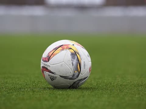 Adidas soccer ball on a grass pitch (Unsplash)
