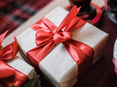 Brown gift box with red ribbon and bow